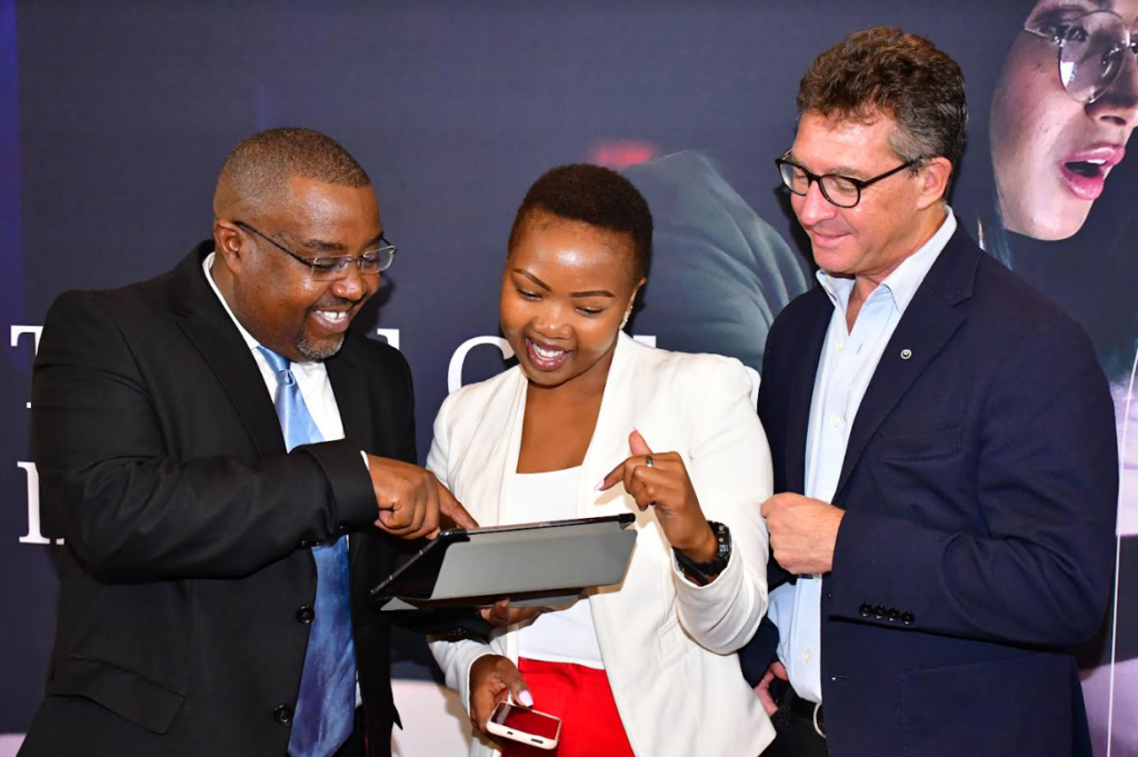 NTT Data East Africa General Manager, Managed Services Peter Gitonga (left) shows Felicity Gitonga of Africa Business News Editor (Center) how the cyber security portal works during the launch of the company’s managed services at a Nairobi Hotel. Looking on is Richard Hechle (right), Managing Director NTT Data East Africa.