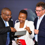 NTT Data East Africa General Manager, Managed Services Peter Gitonga (left) shows Felicity Gitonga of Africa Business News Editor (Center) how the cyber security portal works during the launch of the company’s managed services at a Nairobi Hotel. Looking on is Richard Hechle (right), Managing Director NTT Data East Africa.