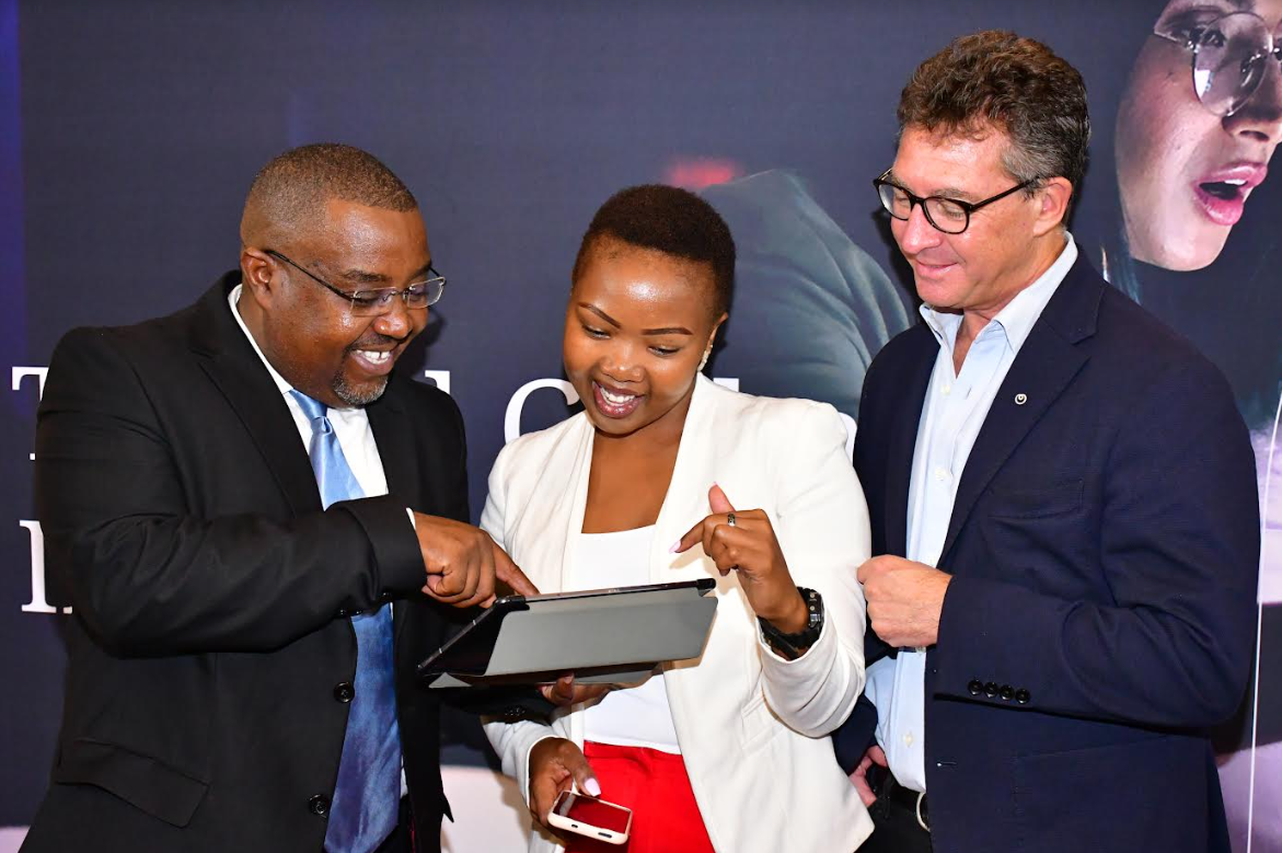 NTT Data East Africa General Manager, Managed Services Peter Gitonga (left) shows Felicity Gitonga of Africa Business News Editor (Center) how the cyber security portal works during the launch of the company’s managed services at a Nairobi Hotel. Looking on is Richard Hechle (right), Managing Director NTT Data East Africa.